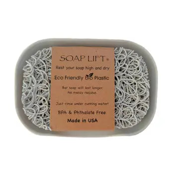 Soap lift showing the fit inside a gray soap dish with a cardboard label on a white background. Soap lift and dish sold seperately.