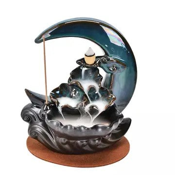 Cone incense burner that looks like the moon. Incense cone placed in middle with visible smoke running down into the bowl attached
