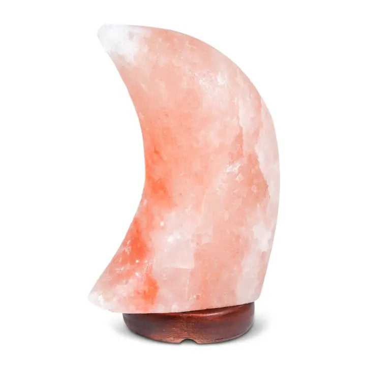 A moon-shaped pink Himalayan salt lamp with a warm light glowing from within.