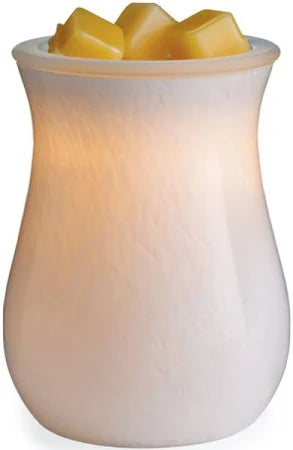 White wax warmer with three yellow wax melts on a white background