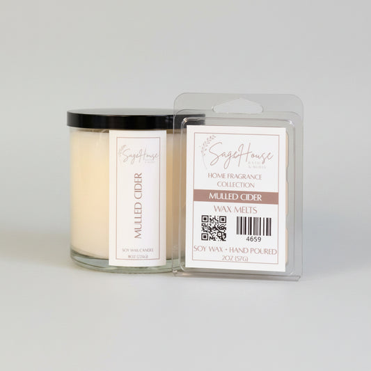A white soy wax candle in a clear container, next to a clear clamshell wax melt package. On a neutral background.