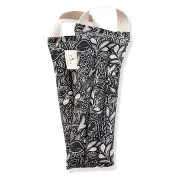 A neck wrap therapy pack with a mushroom and foliage design on a dark blue fabric. displayed on a white background.