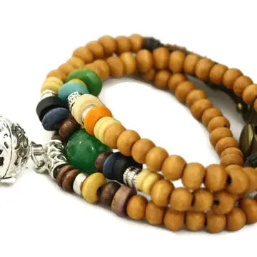 bracelet with brown beads, and green, blue & yellow beaded accents. lava bead inside of silver ball