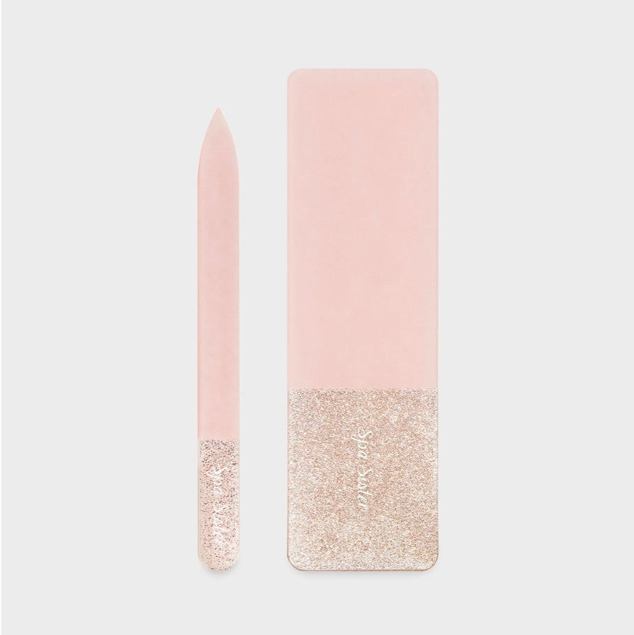 Nude glass nail file with glittery bottom half on a light gray background
