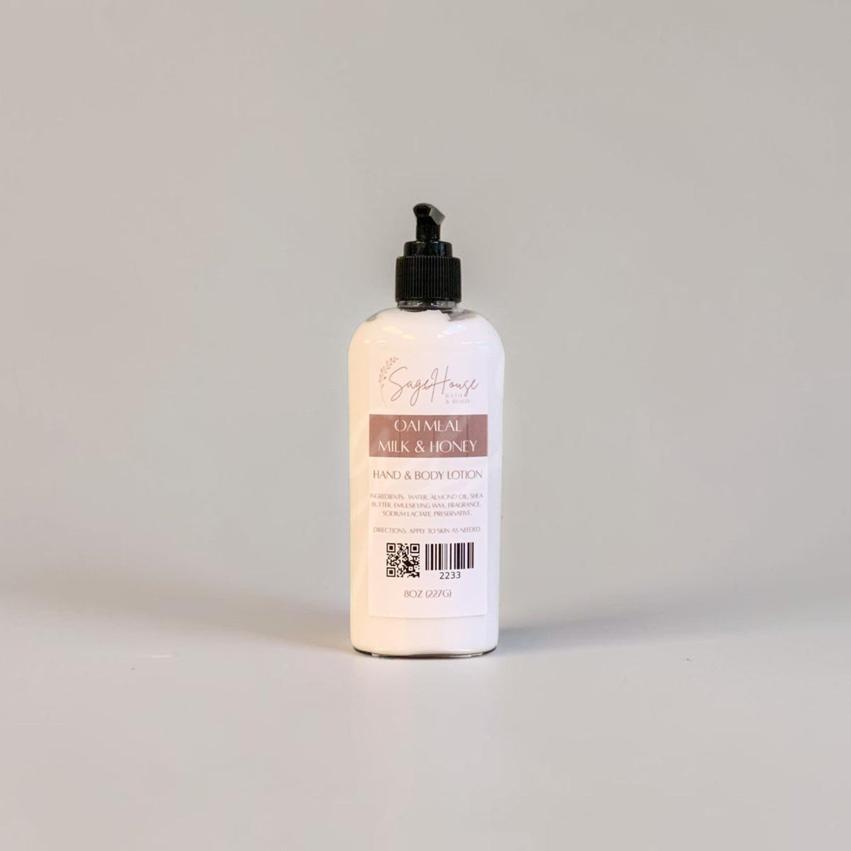 A large bottle of lotion with black pump top and white label. On a white background.