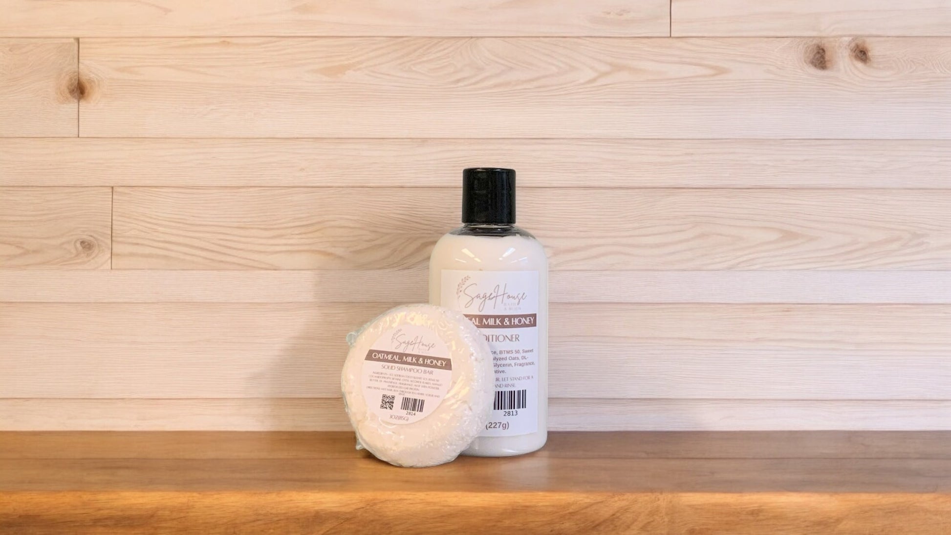 A Oatmeal Milk & Honey shampoo bar and bottle of conditioner on a wooden surface