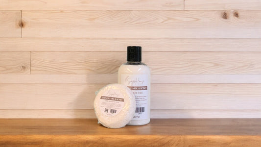 A Oatmeal Milk & Honey shampoo bar and bottle of conditioner on a wooden surface