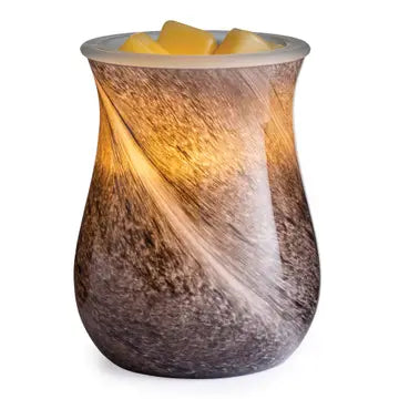 Decorative candle warmer with a textured surface on a white background