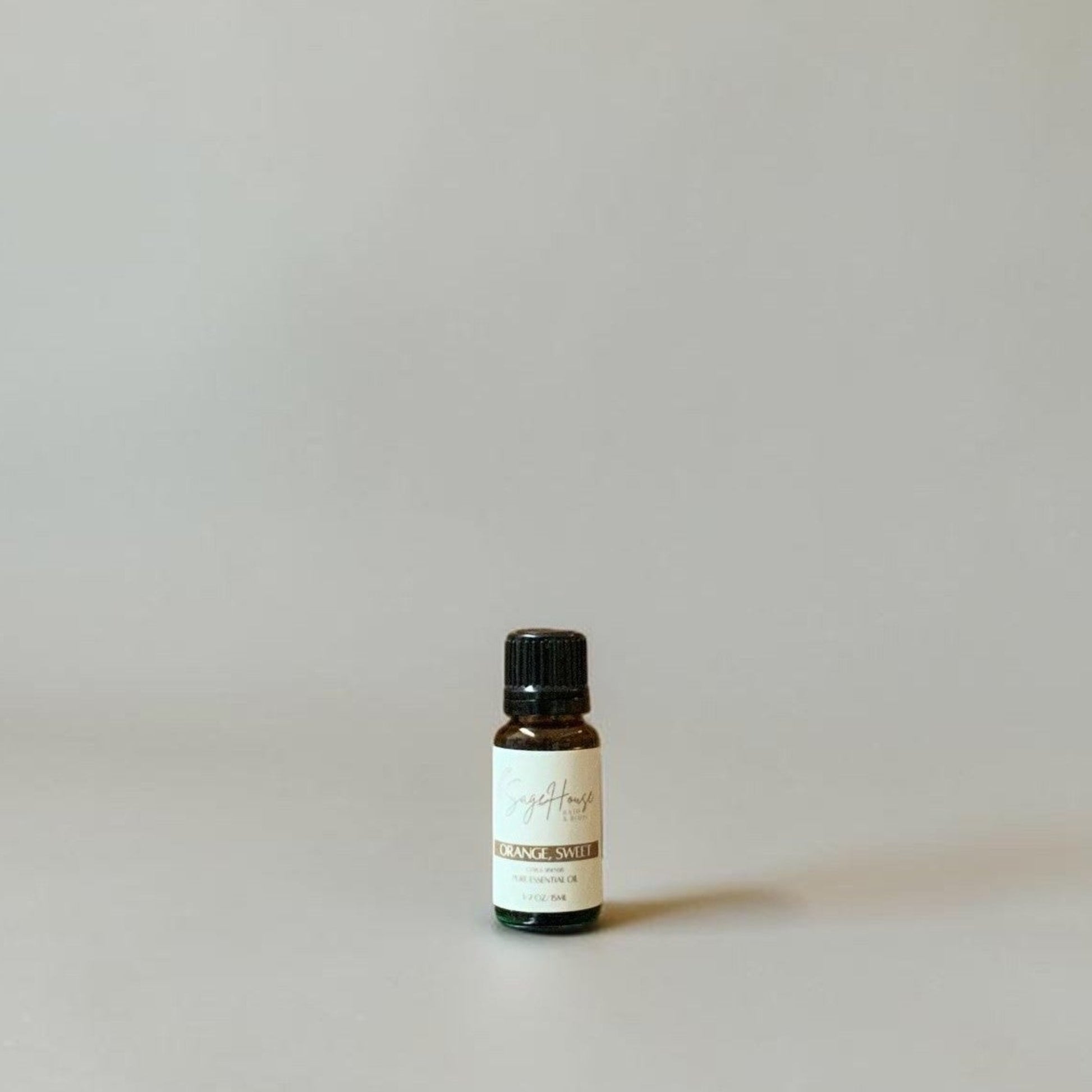 Bottle of Essential oil on a grey background.