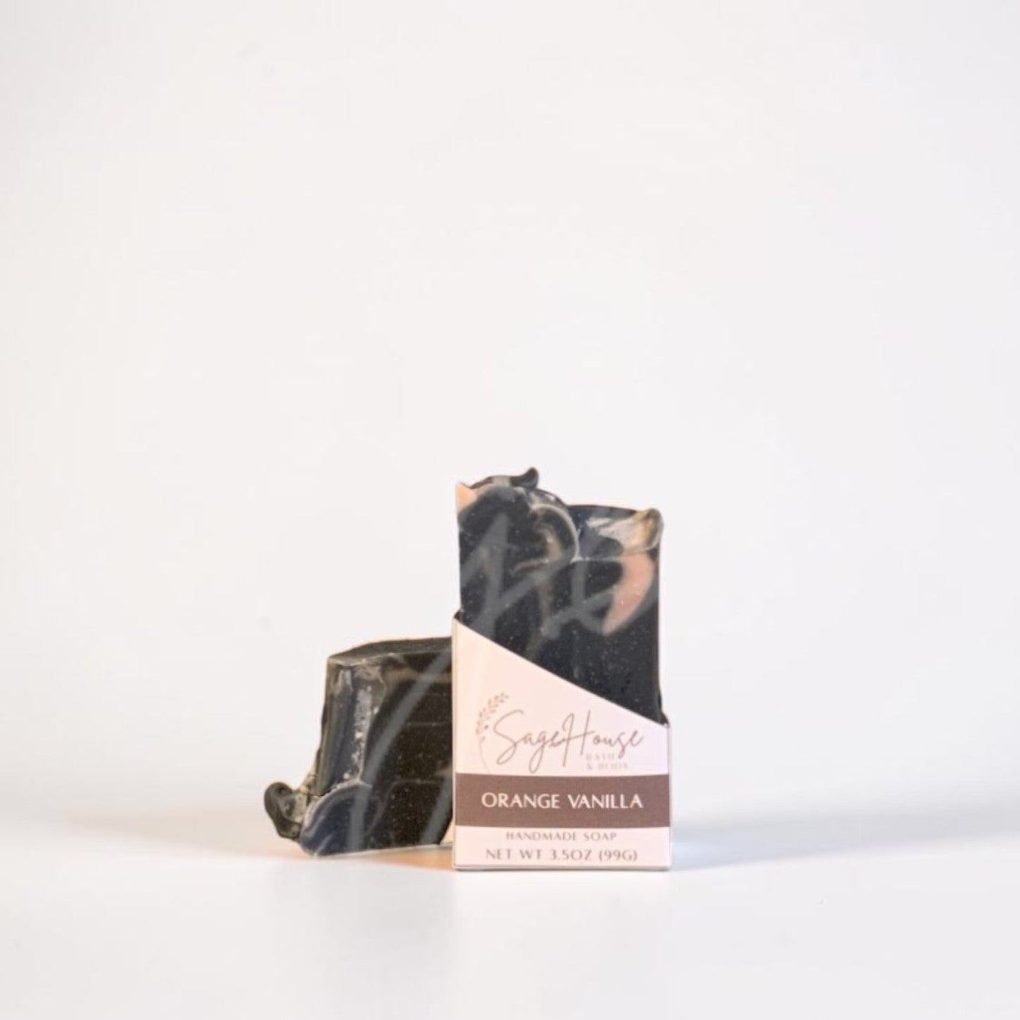 A labeled bar of soap sitting in front of a matching bar. On a white background.