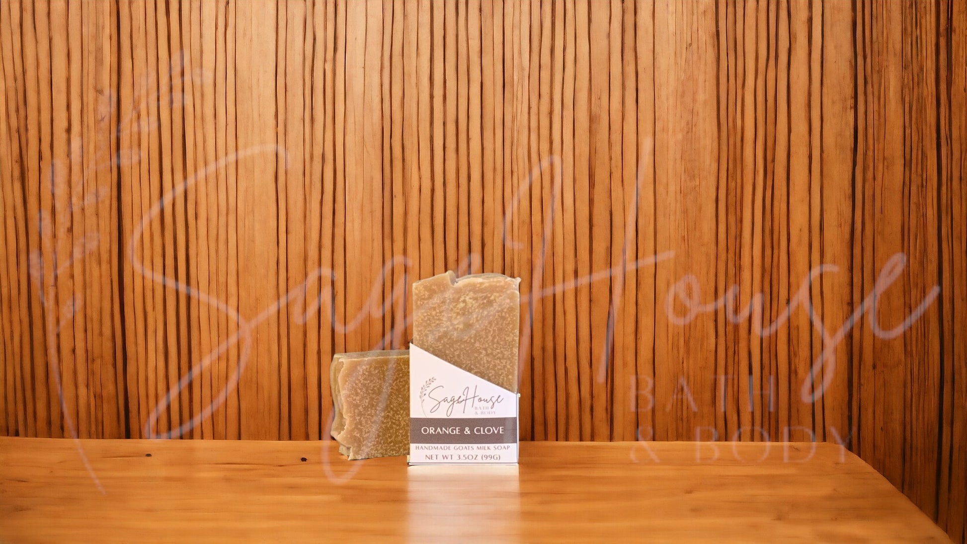A tan bar of soap in a white labeled box, on a wood surface.