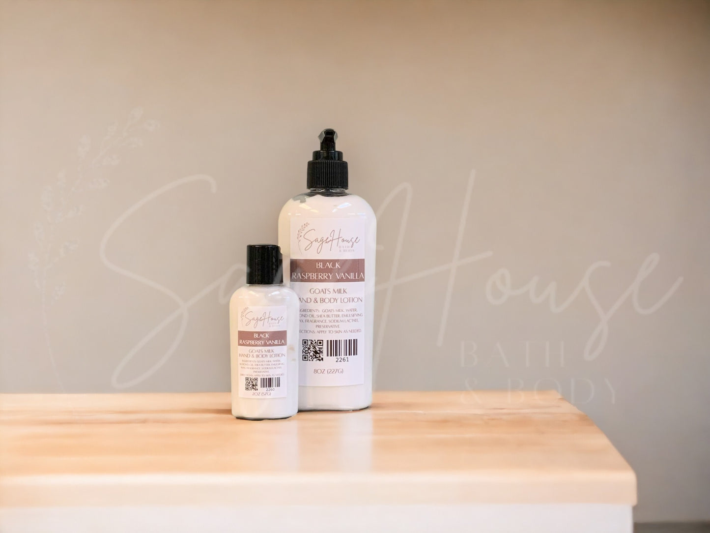 Two bottles of lotion with black caps on a wooden surface with a neutral background