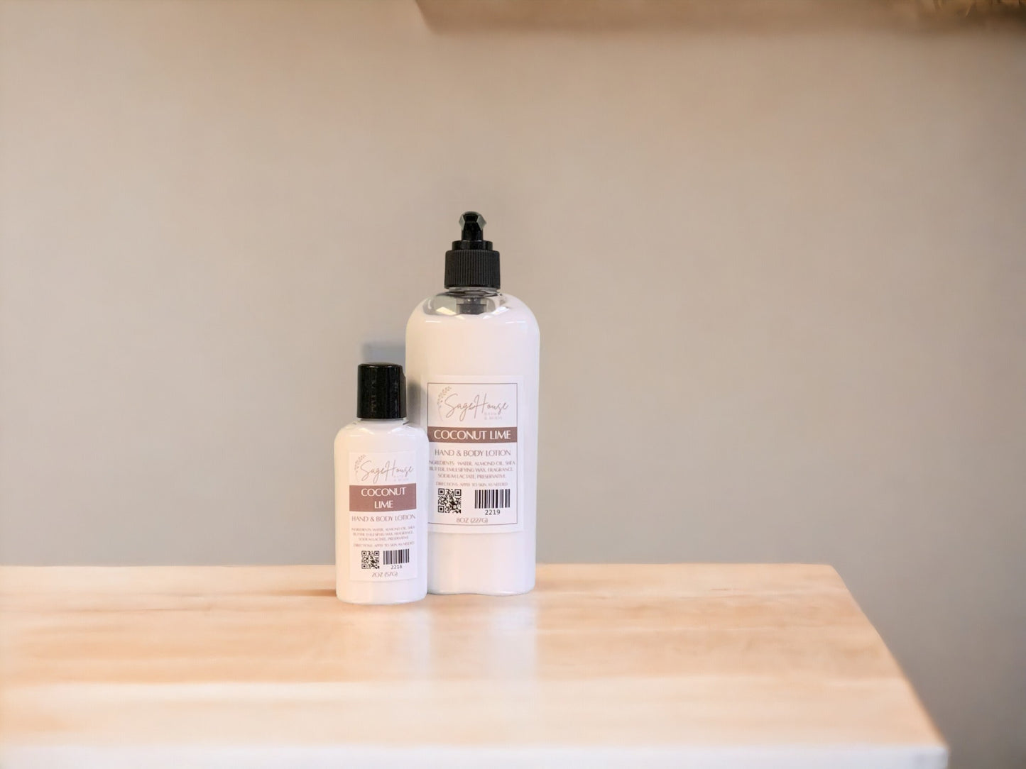 Two bottles of lotion with black caps on a light wooden surface with a tan background