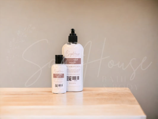 Two bottles of lotion with black caps on a wooden surface with a neutral background