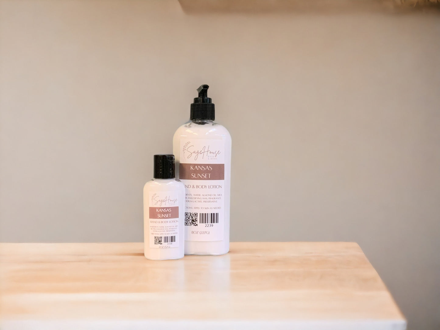 Two bottles of lotion with black caps on a light wooden surface with a tan background