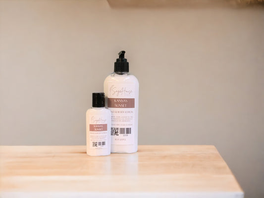 Two bottles of lotion with black caps on a light wooden surface with a tan background
