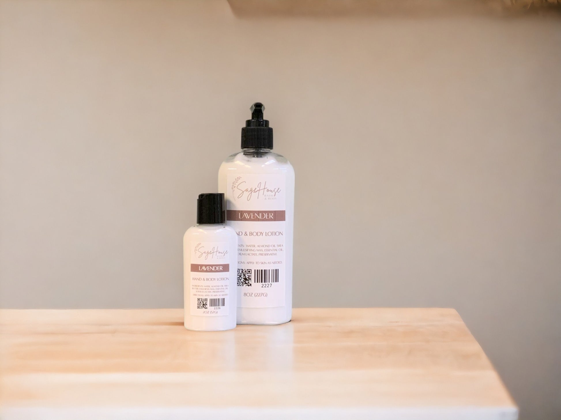 Two bottles of lotion with black caps on a light wooden surface with a tan background