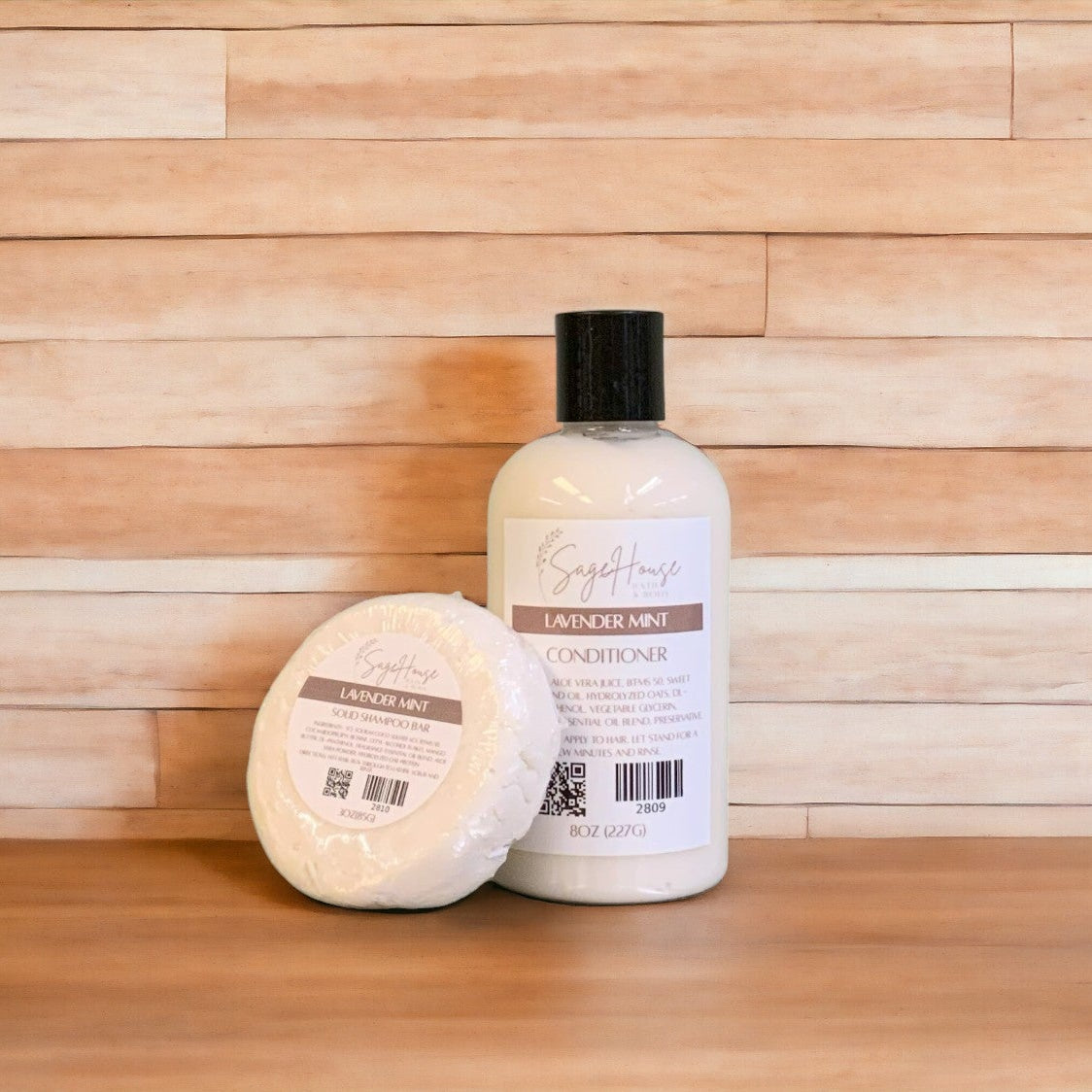 A Lavender Mint shampoo bar & bottle of conditioner on a wooden surface.
