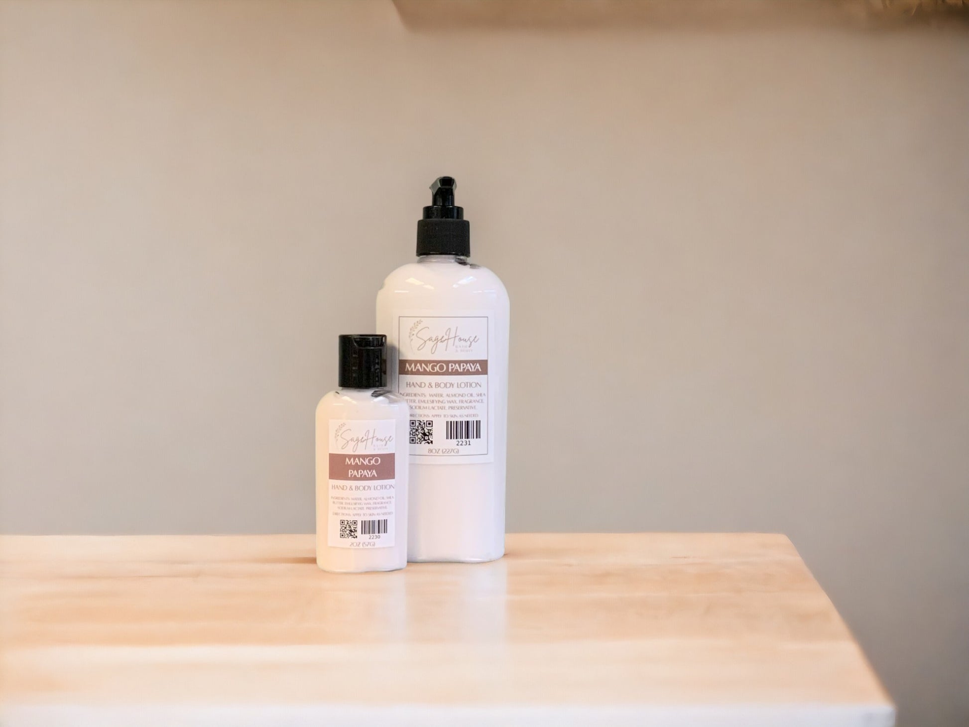 Two bottles of lotion with black caps on a light wooden surface with a tan background