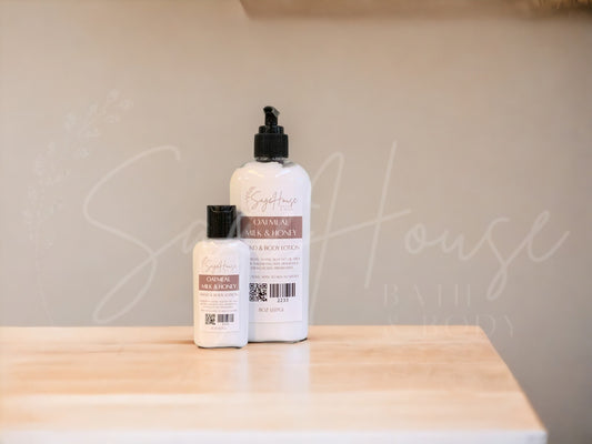 Two bottles of lotion with black caps on a wooden surface with a neutral background