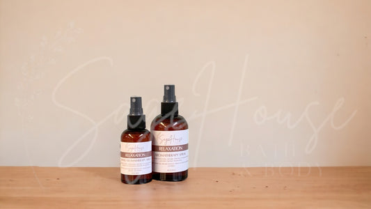 2 Amber colored spritz bottles with relaxation labels, on wood surface