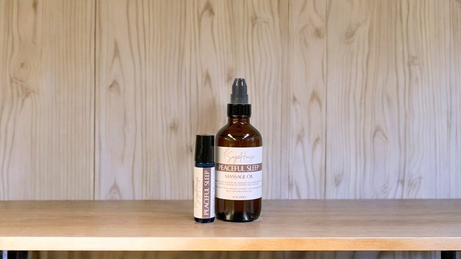A bottle with a treatment pump, and a roller bottle labeled with 'Peaceful sleep Massage Oil', positioned on a wooden surface.