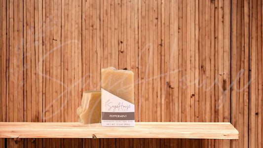 A tan colored bar of soap with a white label. on a wood surface.