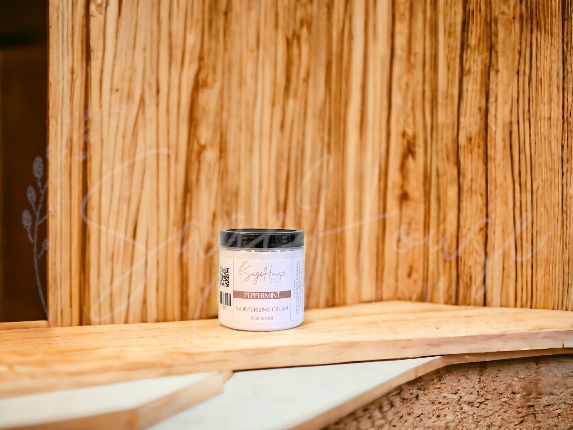 A jar of Peppermint Moisturizing Cream with a wood background