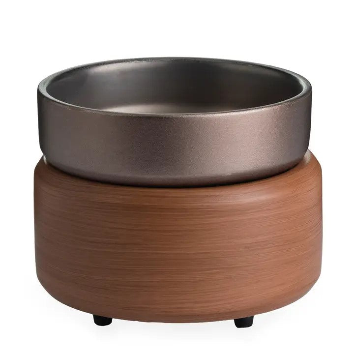 A wax melt warmer with a medium wood looking base and a pewter colored top to place wax melts.