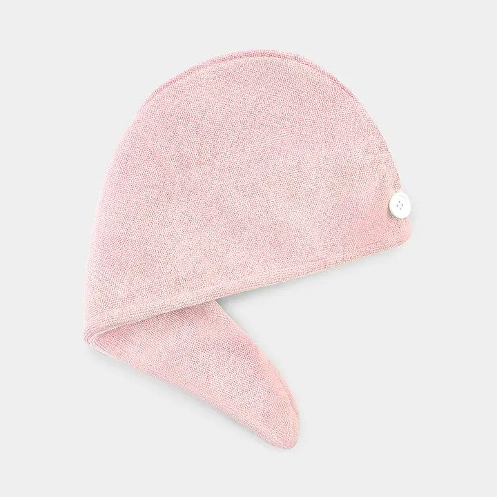 A pink microfiber hair turban with a button fastener designed to wrap around the head.