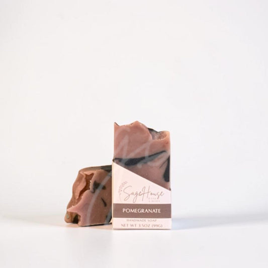 A single bar of soap in a labeled sleeve, standing upright next to a matching bar on a clean white studio background.