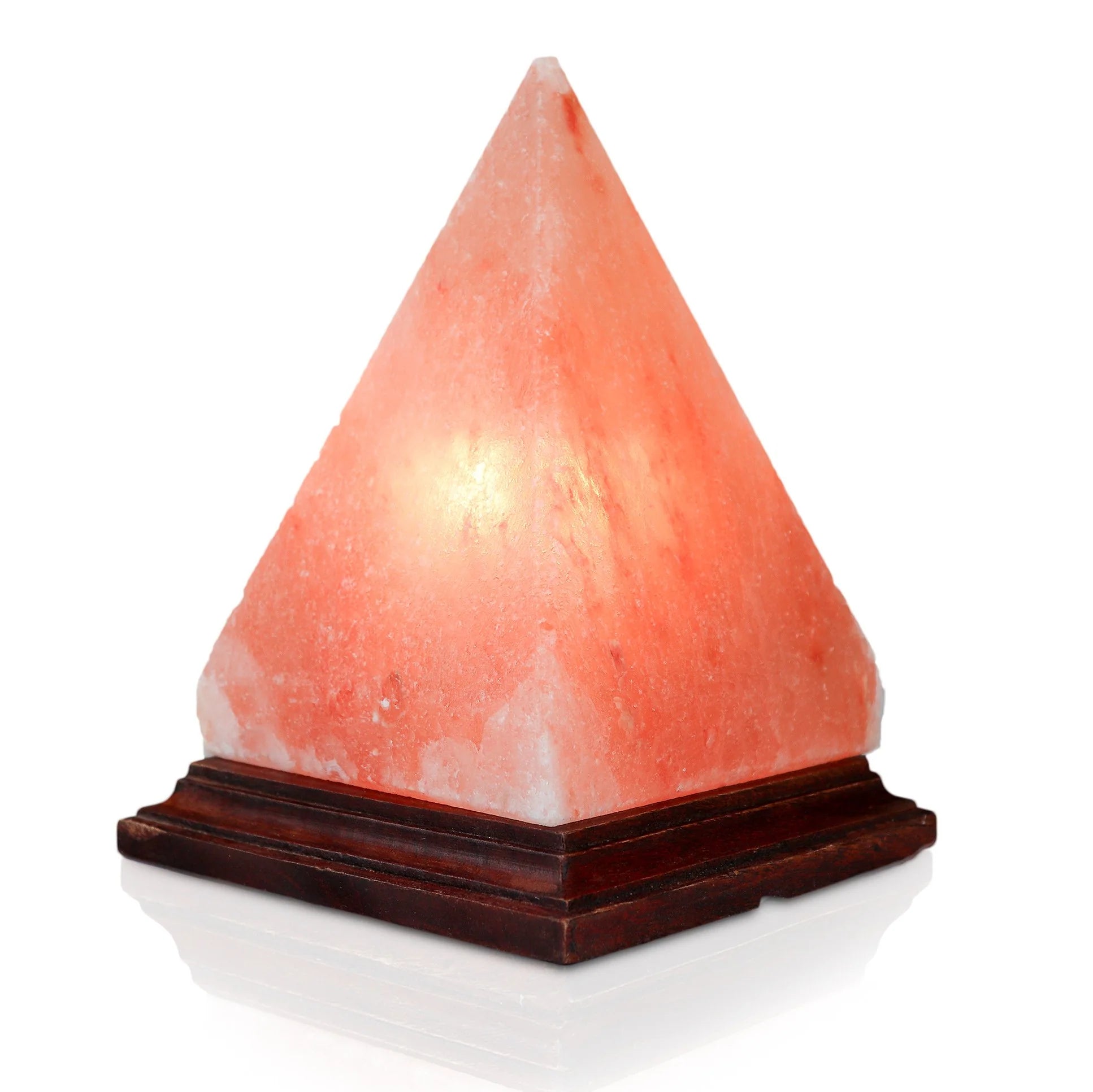 A triangular pyramid-shaped Himalayan salt lamp with a warm pink glow, placed on a wooden base.