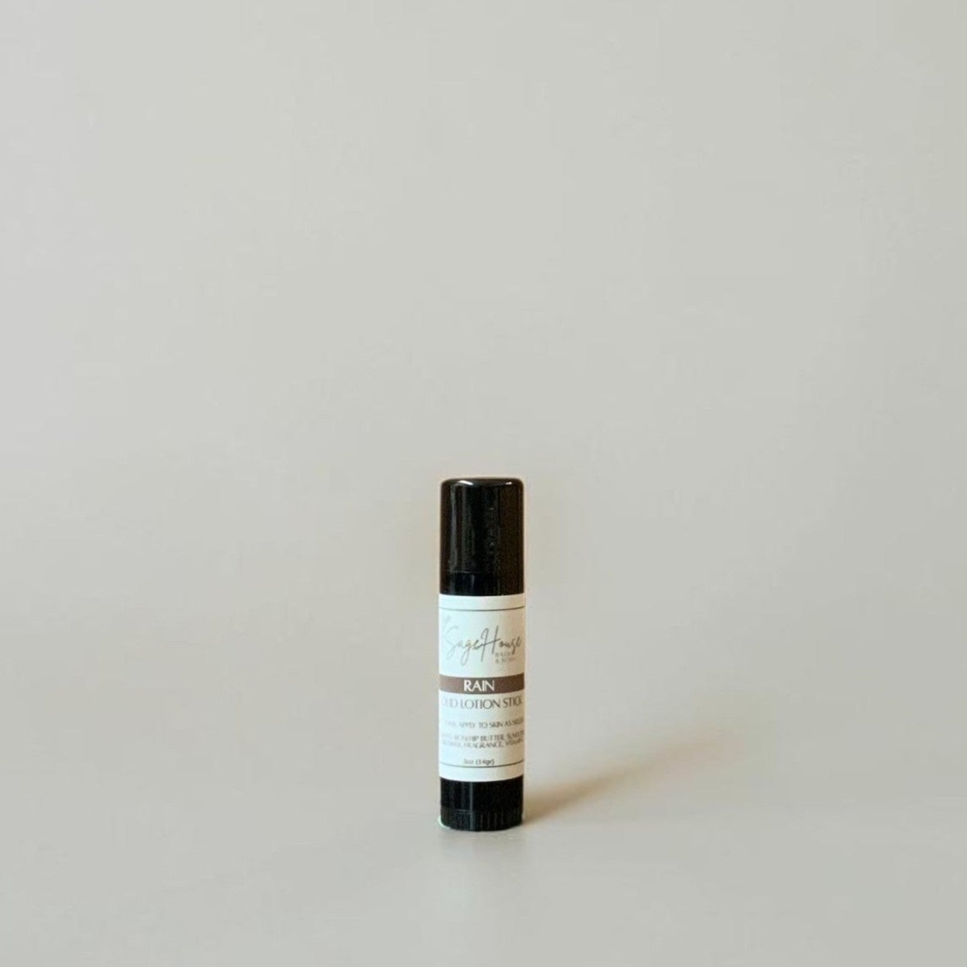 A black tube with label on a light gray background