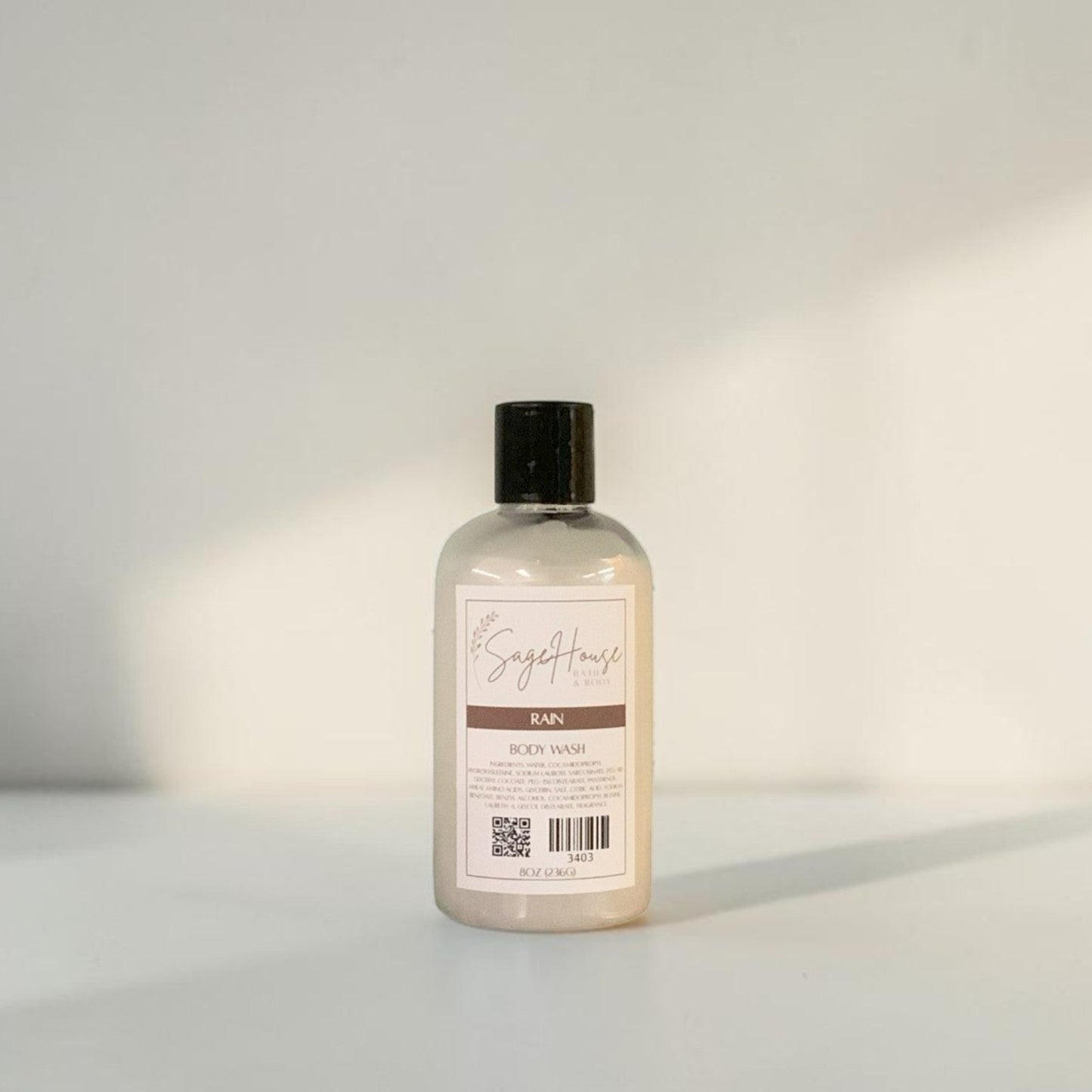 Clear bottle with black cap on a light gray background