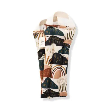 A neck wrap therapy pack with a outdoor playful hill and rainbow design in multicolor, primarily in shades of orange, blue, and beige, displayed on a white background.