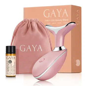 Pink GAYA beauty device, bottle of facial oil, and packaging on a white background