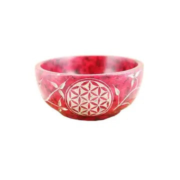 A Soapstone Bowl red color, and flower designs on a white background