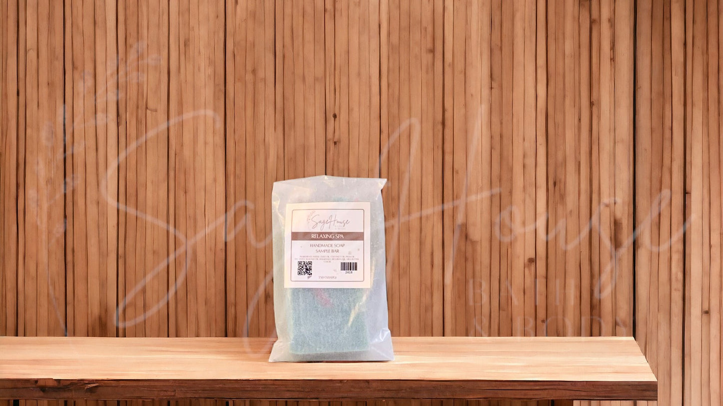 A sample bar of soap in a glassine bag. placed on a wood surface.