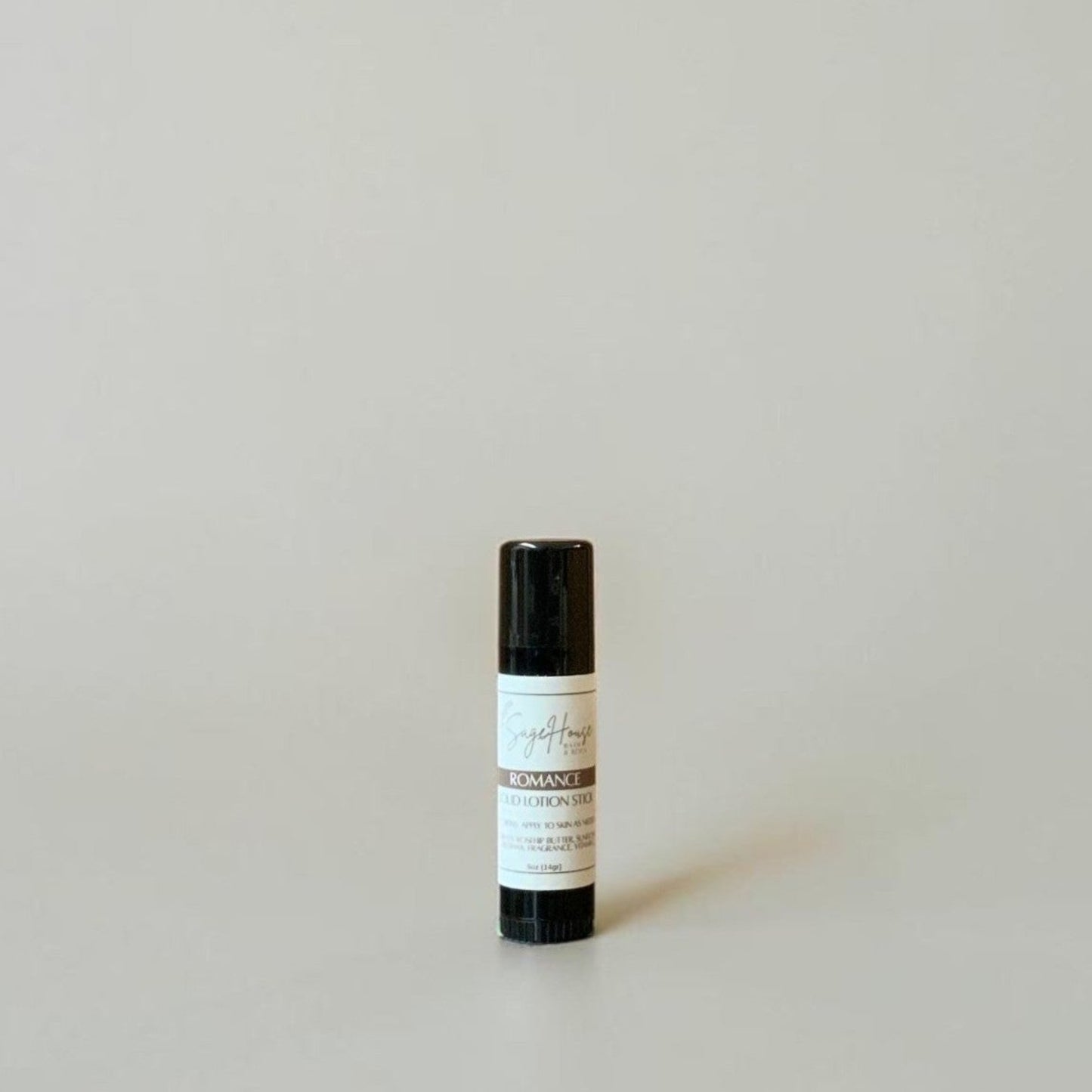 A black tube with label on a light gray background