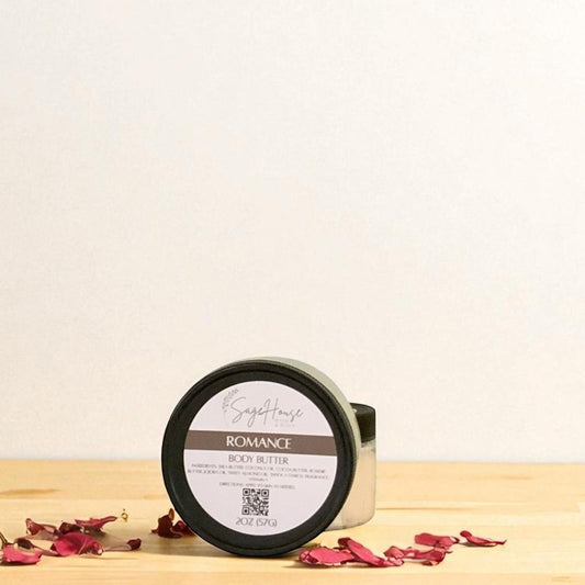 Jar of 'Romance' body butter on a wooden surface with dried flowers