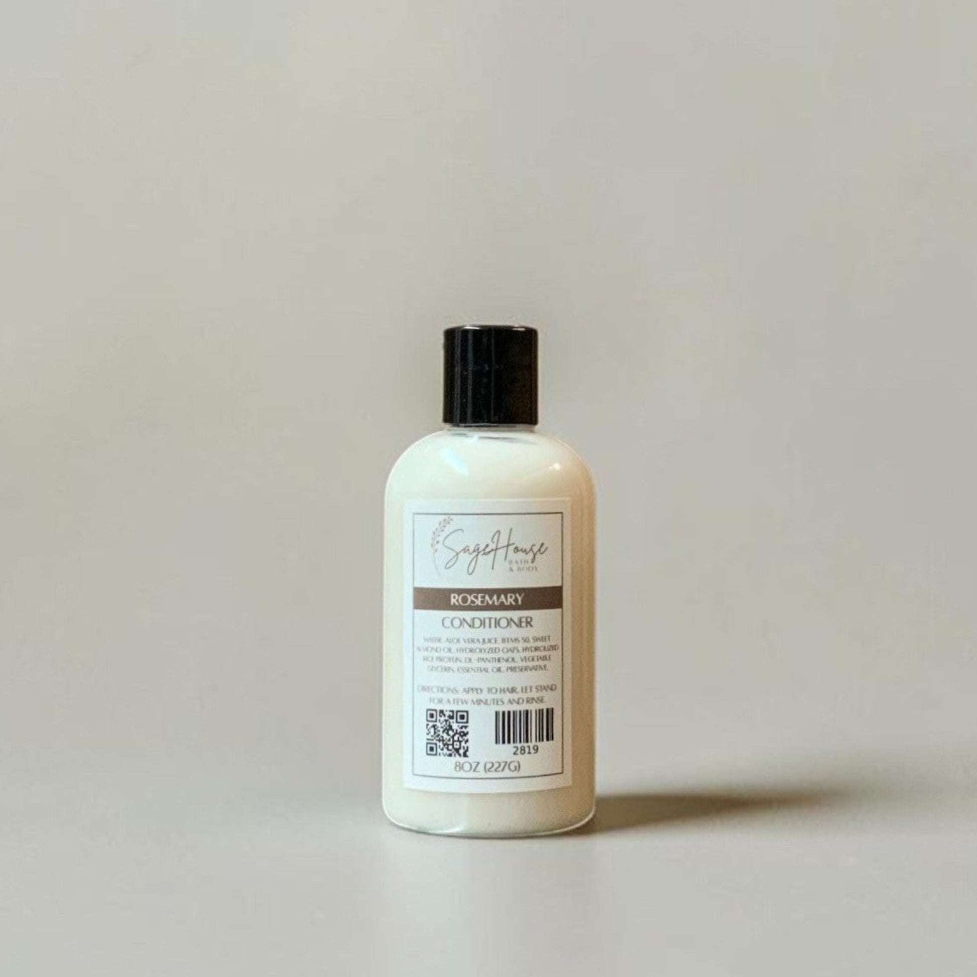White bottle with black cap on a light gray background