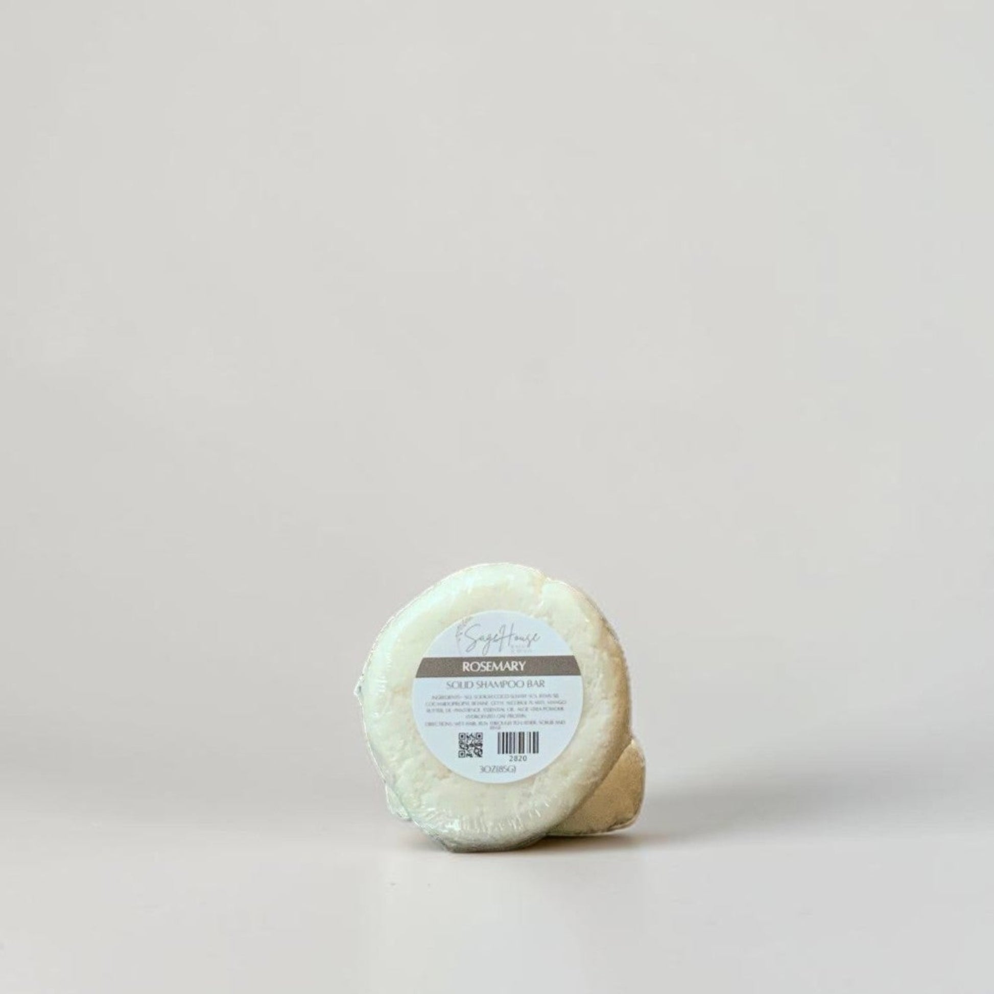A round shampoo bar with label on a white background.