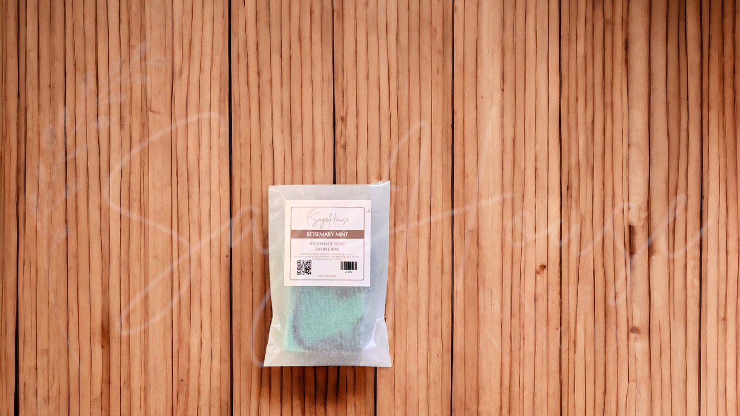 A sample bar of soap in a glassine bag. placed on a wood surface.