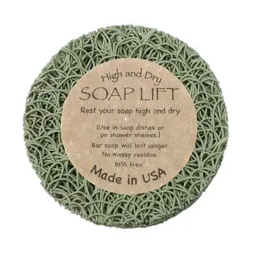 A round sage soap lift with product label in the middle. On white background.