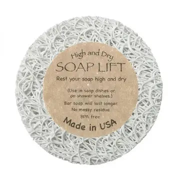 A round white soap lift with product label in the middle. On white background.