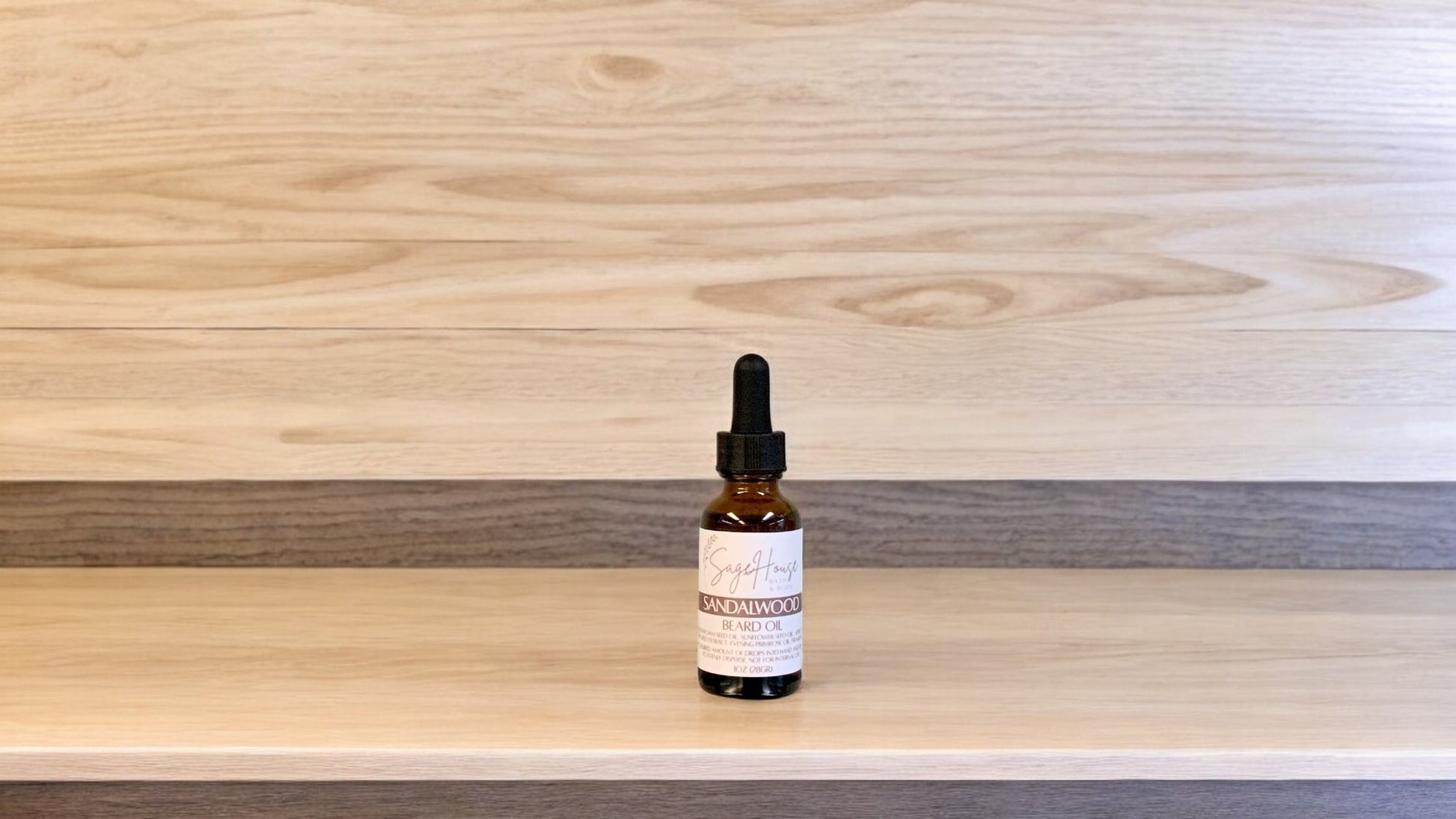 A dropper bottle labeled "sandalwood" on a wood top and background