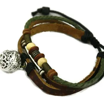 bracelet with brown leather and neutral & dark beaded accents. lava bead inside of silver ball