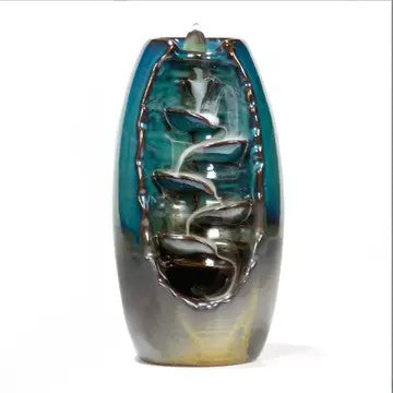Large blue and green tone cone incense burner with waterfall type steps going up the middle. Cone on top with visible smoke moving down into the tray below