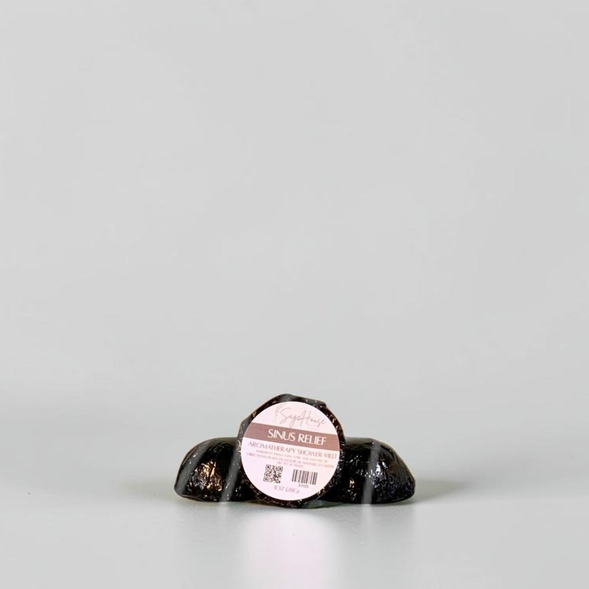One labeled shower melt propped in front of 2 other shower melts. Sitting on a white background.