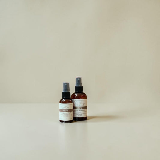 Two brown spray bottles with labels on a beige background